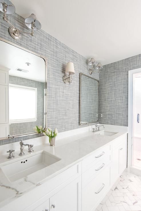 Beautiful white and gray bathroom is clad in gray textured wallpaper