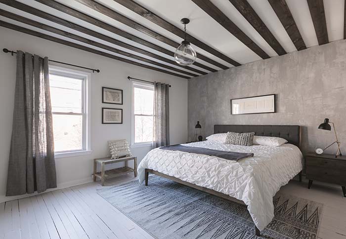 gray bedroom with stained pine ceiling planks