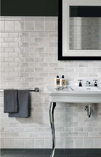 Marble subway tile that looks like glass and hardwood or porcelain .