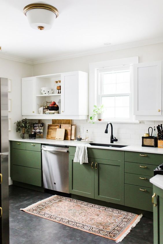 a chic contemporary kitchen with green and white cabinets, gold handles and white countertops plus a boho rug