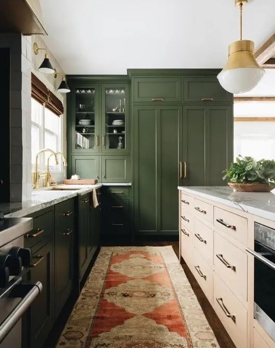 a dark green kitchen, a light colored wood kitchen island, white stone countertops and gold touches for a mid century modern feel