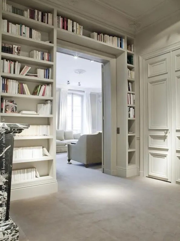 a-doorway-with-built-in-open-shelves-on-both-sides-and-over-the-door-is ...