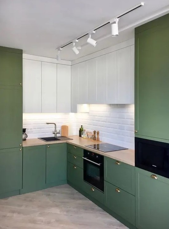 a minimalist olive green and white kitchen with shaker and flat panel cabinets, a white subway tile backsplash and butcherblock countertops