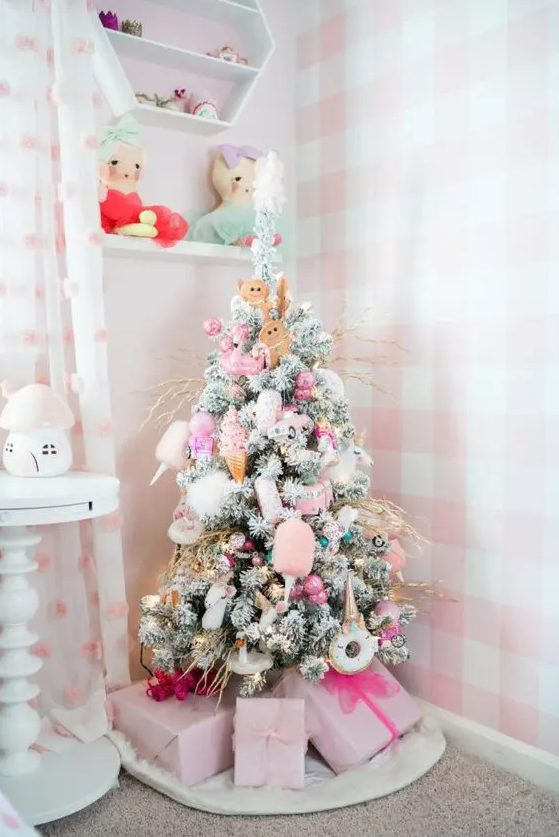 a pastel Christmas tree with lights, pink ornaments and various cuties like donuts, gingerbread men and ice cream