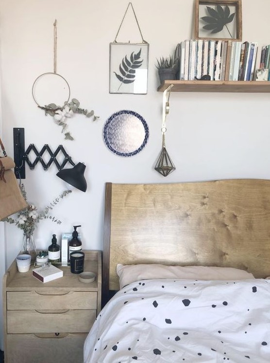 Foliage and green plants in frames, hoops and in a vase create a natural atmosphere in the Nordic bedroom