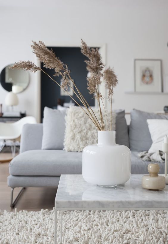 Simple Scandinavian fall decor with a white vase and dried grass is a beautiful and easy solution for fall