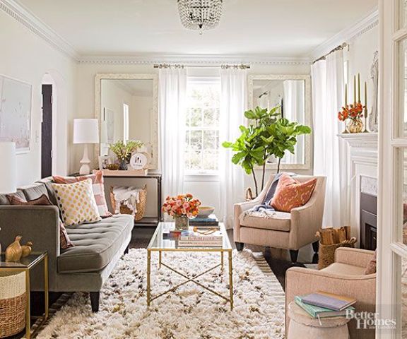 A neutral color palette with warm tones makes this living room cozy and visually larger