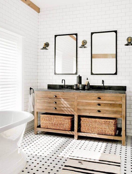 cool mosaic tiles on the floor and a double wooden vanity with baskets for storage