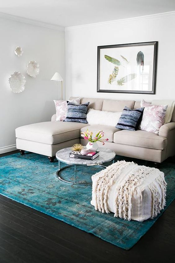 A turquoise rug is the only colorful piece here and it makes a statement