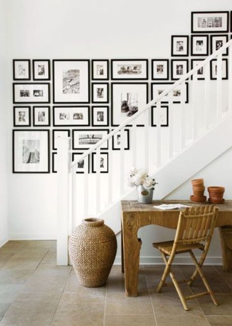 A free-form black-and-white gallery wall with family and other photos is a cool solution for a modern space, and matching frames add cohesion