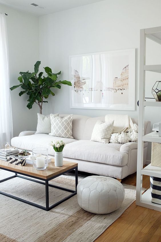 Neutral colors and a medium-sized sofa make the room feel larger