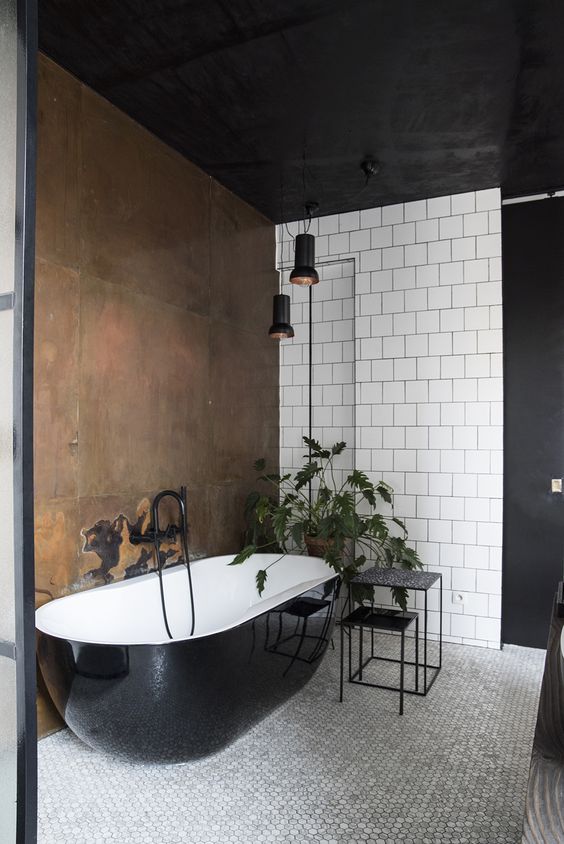 A striking copper wall next to the bathtub highlights this bathing area