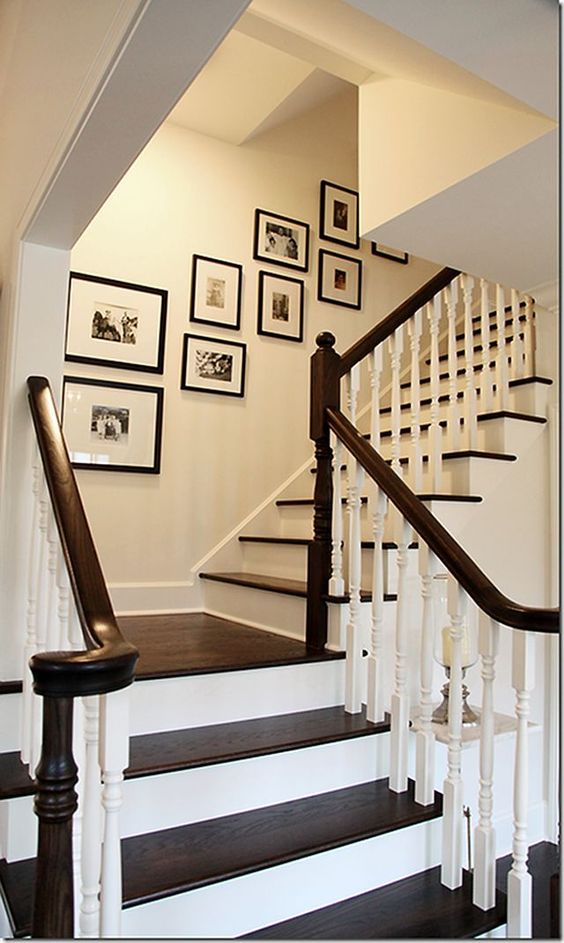 A stylish freeform gallery wall with black and white family photos adds a personal touch to the space