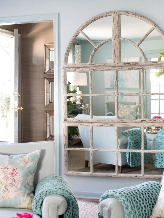 shabby wooden framed mirror covering an entire wall