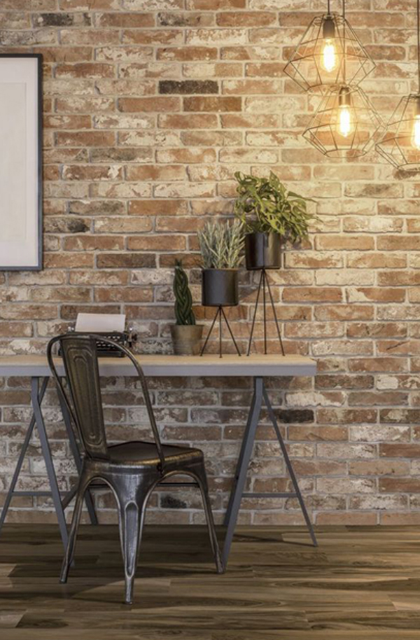 Industrial brick home office with houseplants and pendant light