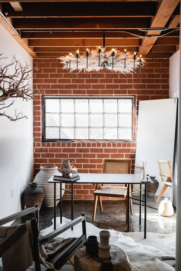 Black metal desk, industrial home office with brick walls
