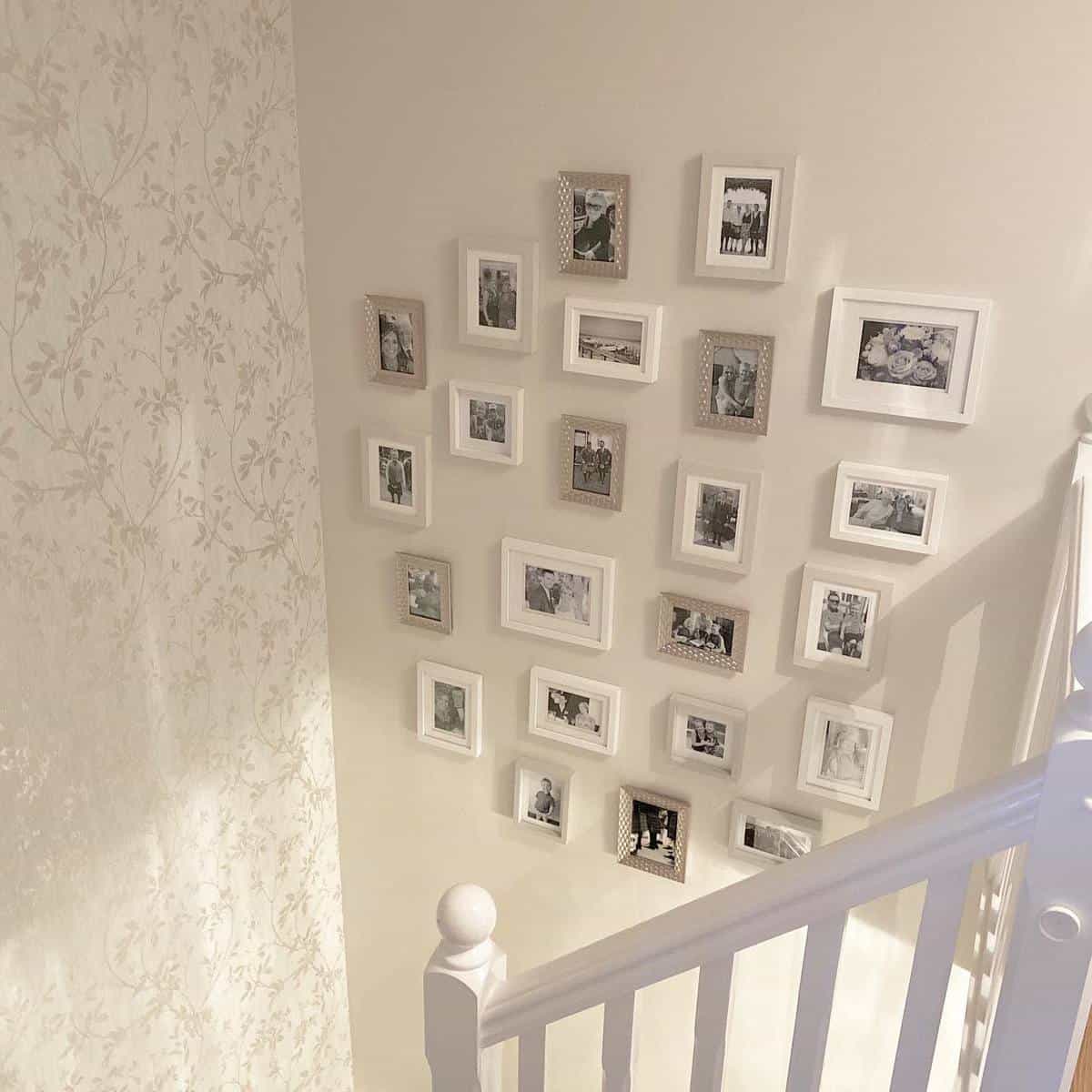 Framed photos on the wall near the stairs 