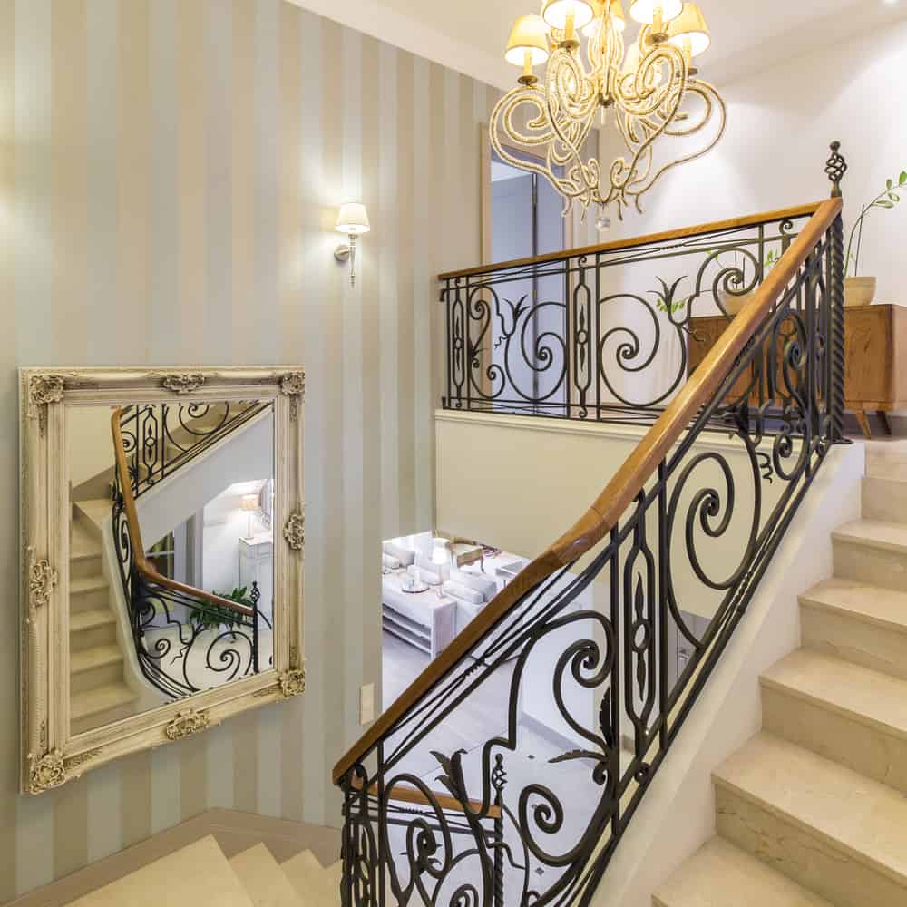 decorated stair railing with wall mirror 