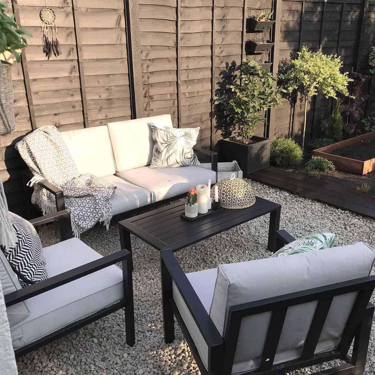 Gravel terrace with black painted furniture 