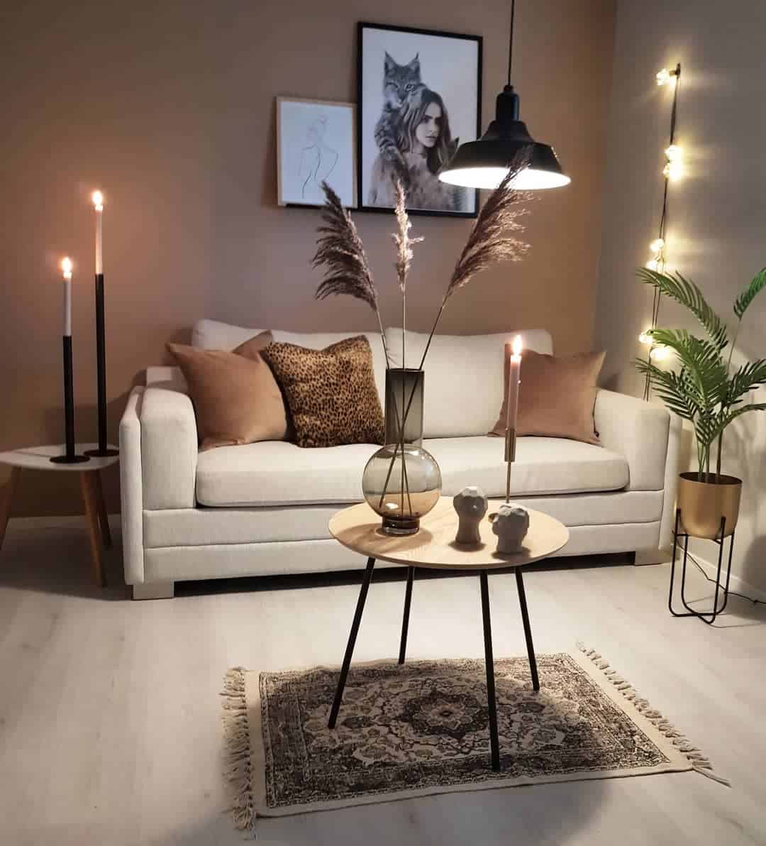 brown accent wall, gray couch candles 