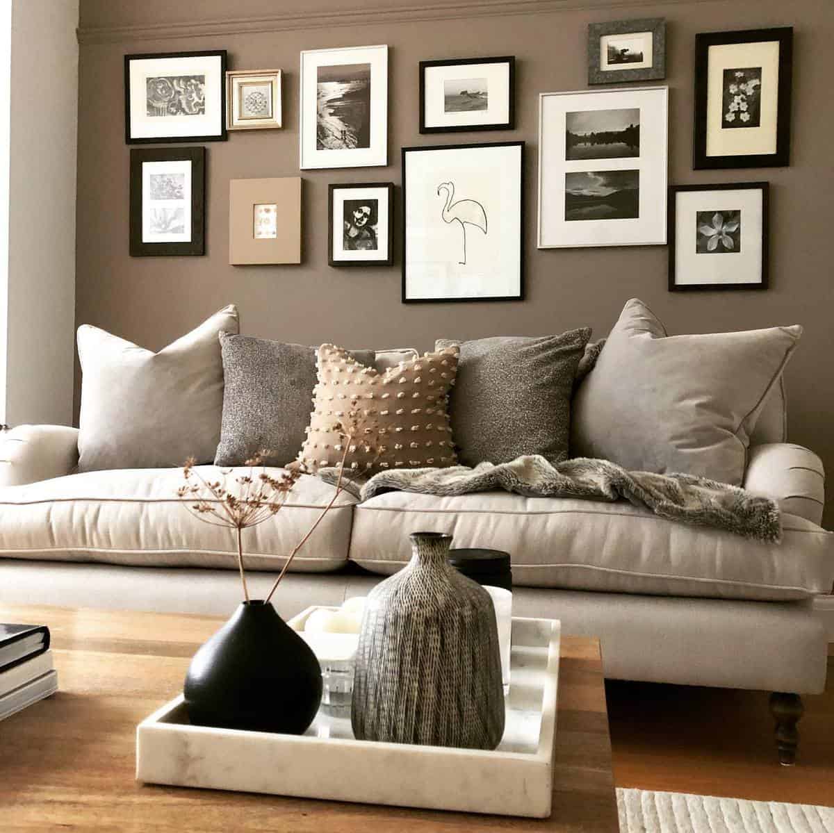 Brown accent wall, framed photos, gray couch