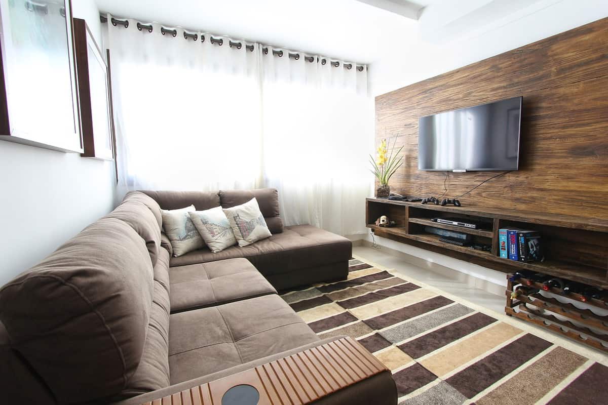 Modern brown living room with wooden wall tv