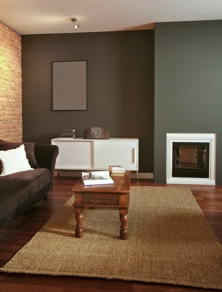 Exposed brickwork, gray wall, living room, fireplace, white cupboard