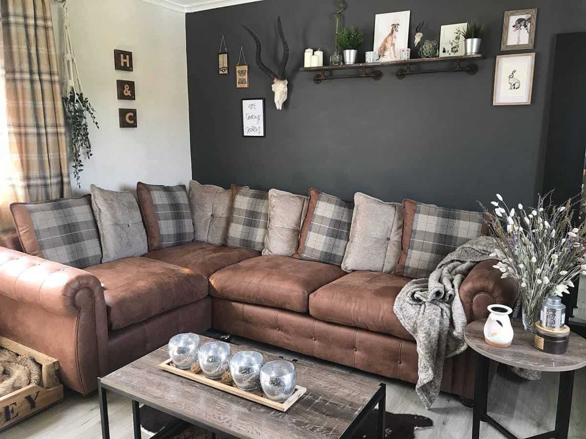 gray accent wall, brown couch, rustic living room