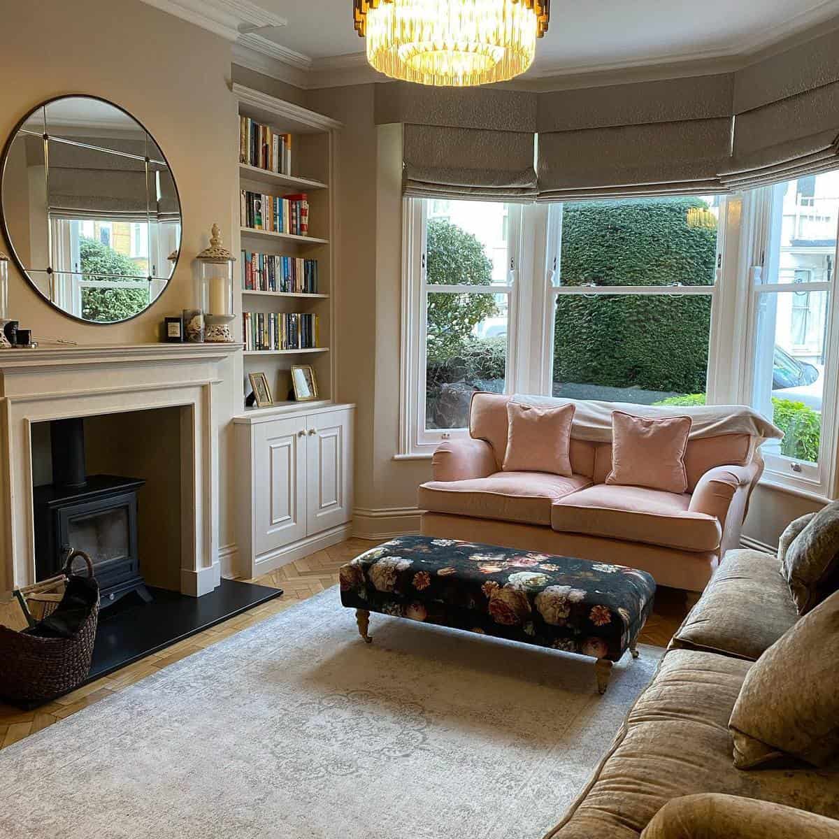 Elegant pink sofa fireplace bookshelf in living room 
