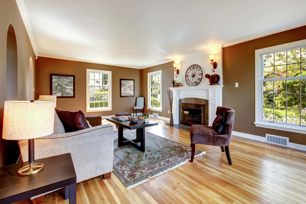 Large cottage living room, brown walls, vinyl floor 