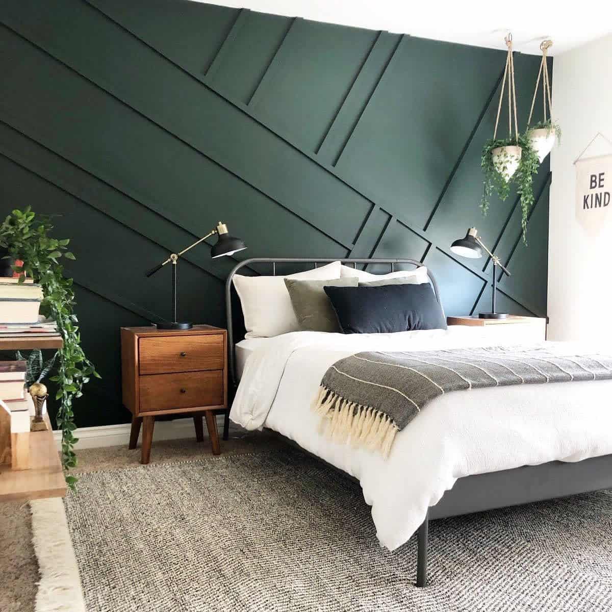 Modern bedroom, green accent wall, gray bed frame, hanging potted plants, wooden bedside table 