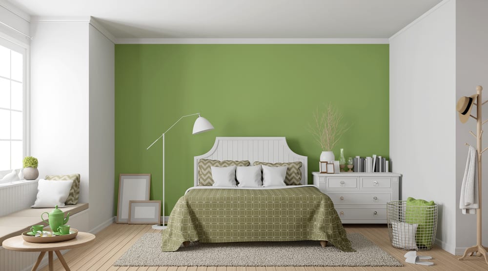 Modern bedroom, green accent wall, white bed frame and cupboards, green tea set with hat rail 