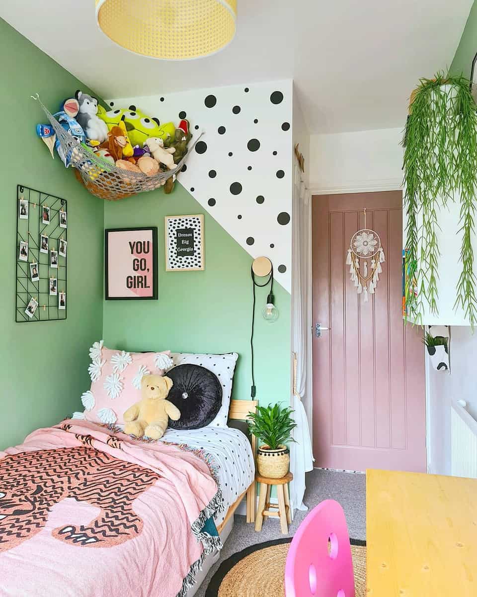 Girl's bedroom, green wall, pink door, toy hammock, photo wall