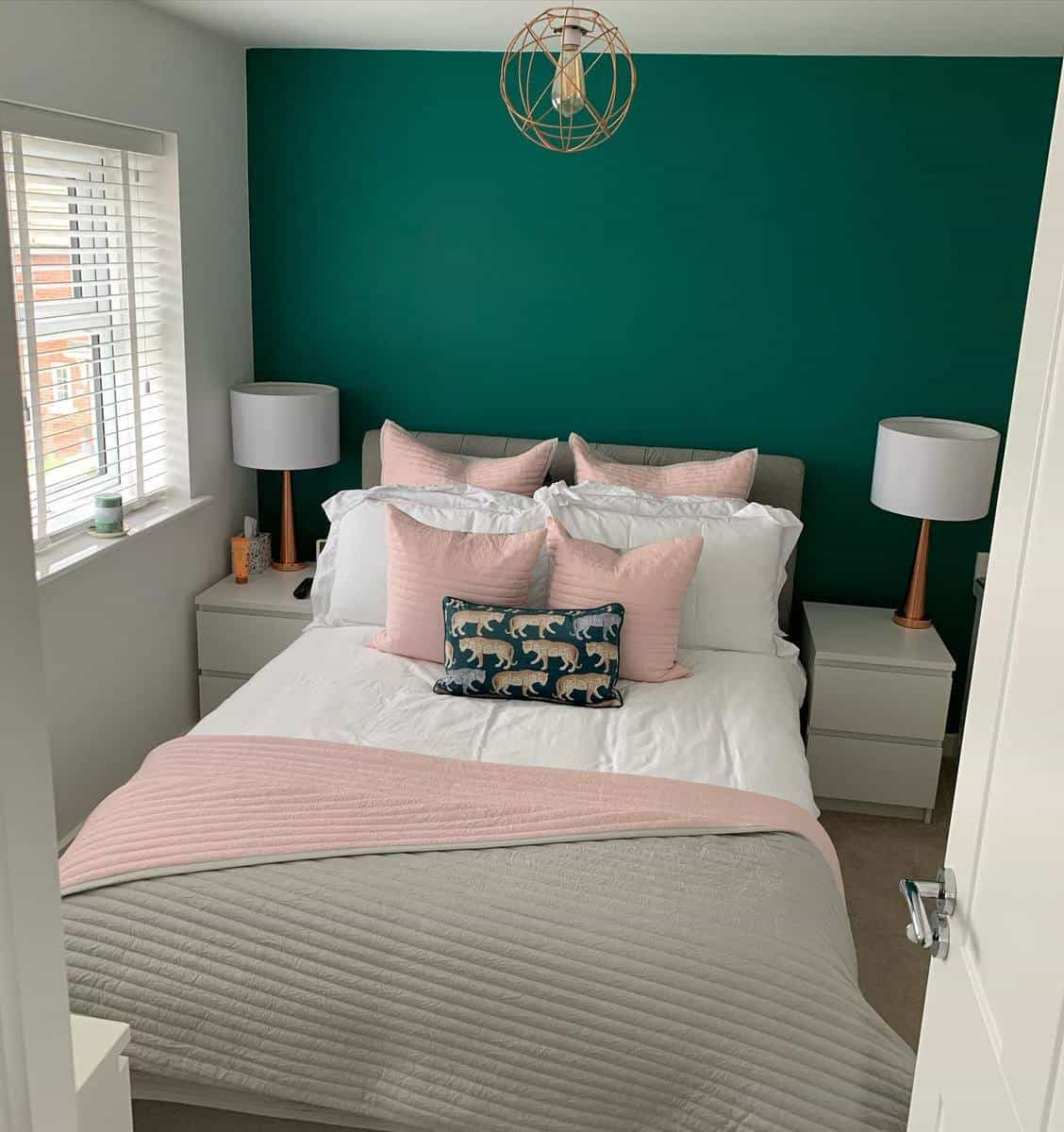 Girl, green bedroom, pink pillows, white Ikea bedside tables, candle