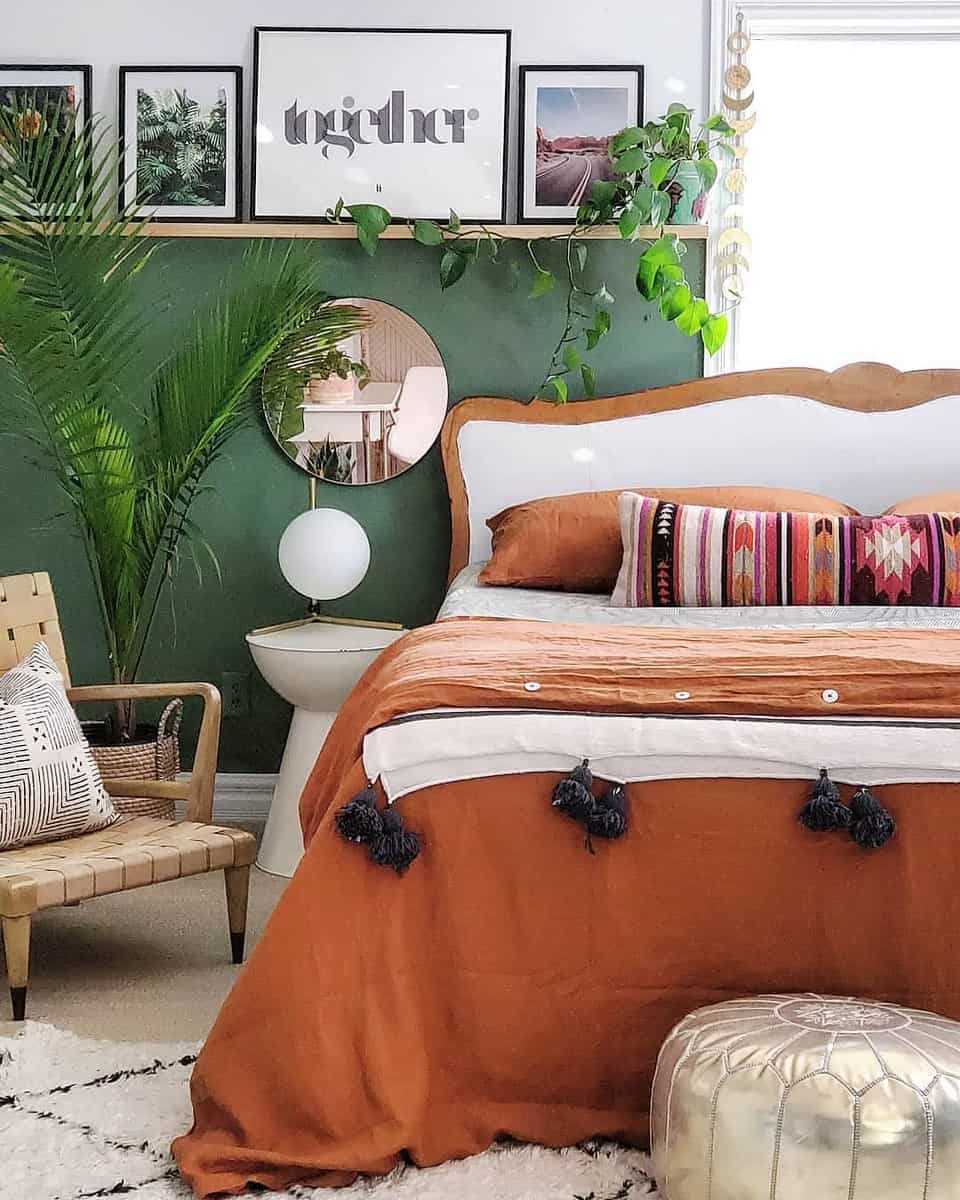 Bedroom, green accent wall, wooden wall shelf, mirror, Mexican style bedspread 
