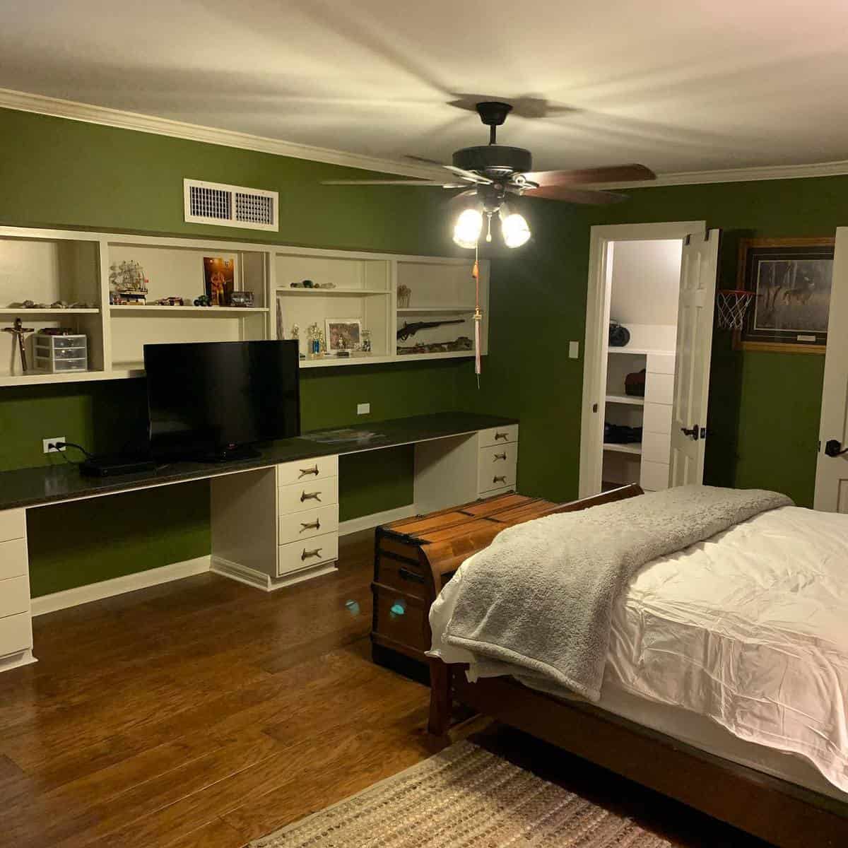 Large bedroom, white cupboards, wall shelves, wooden bed chest 