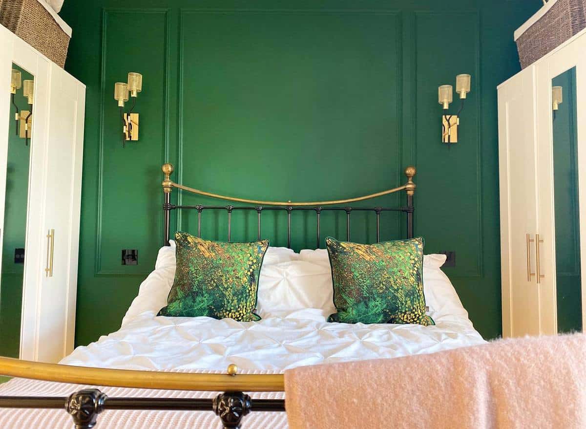 Green wall, rustic bedroom, four post bed frame 