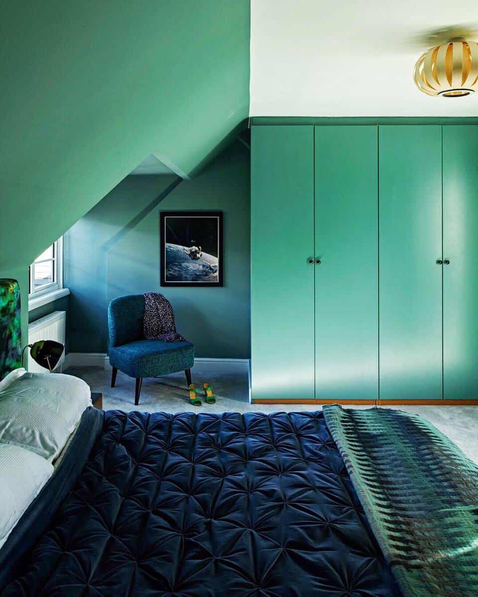 Green attic bedroom wardrobe, accent chair, room wall art 