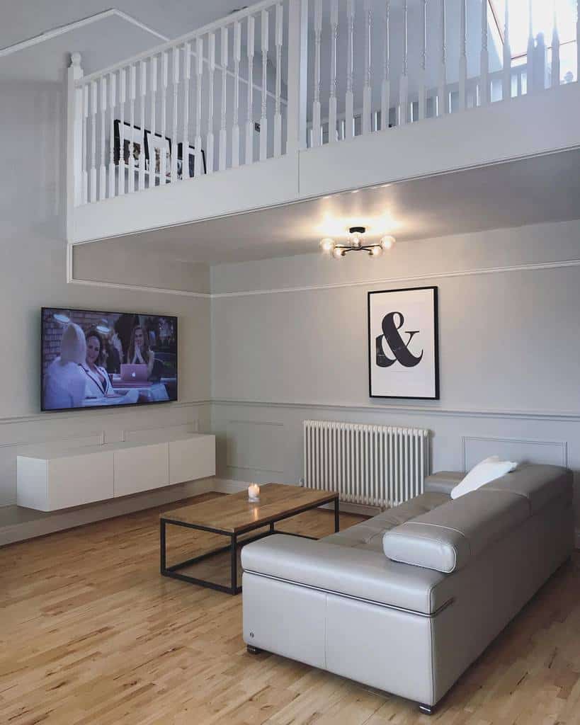 Spacious living room, gray sofa, wall mounted TV