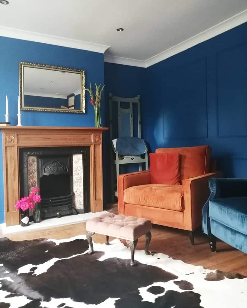 Blue wall, living room fireplace accent sofa chairs 