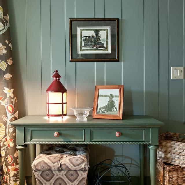 small desk with green wall paneling 