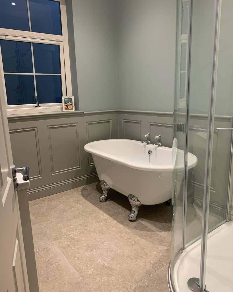 Bathroom, gray wall paneling, free-standing bathtub, shower 