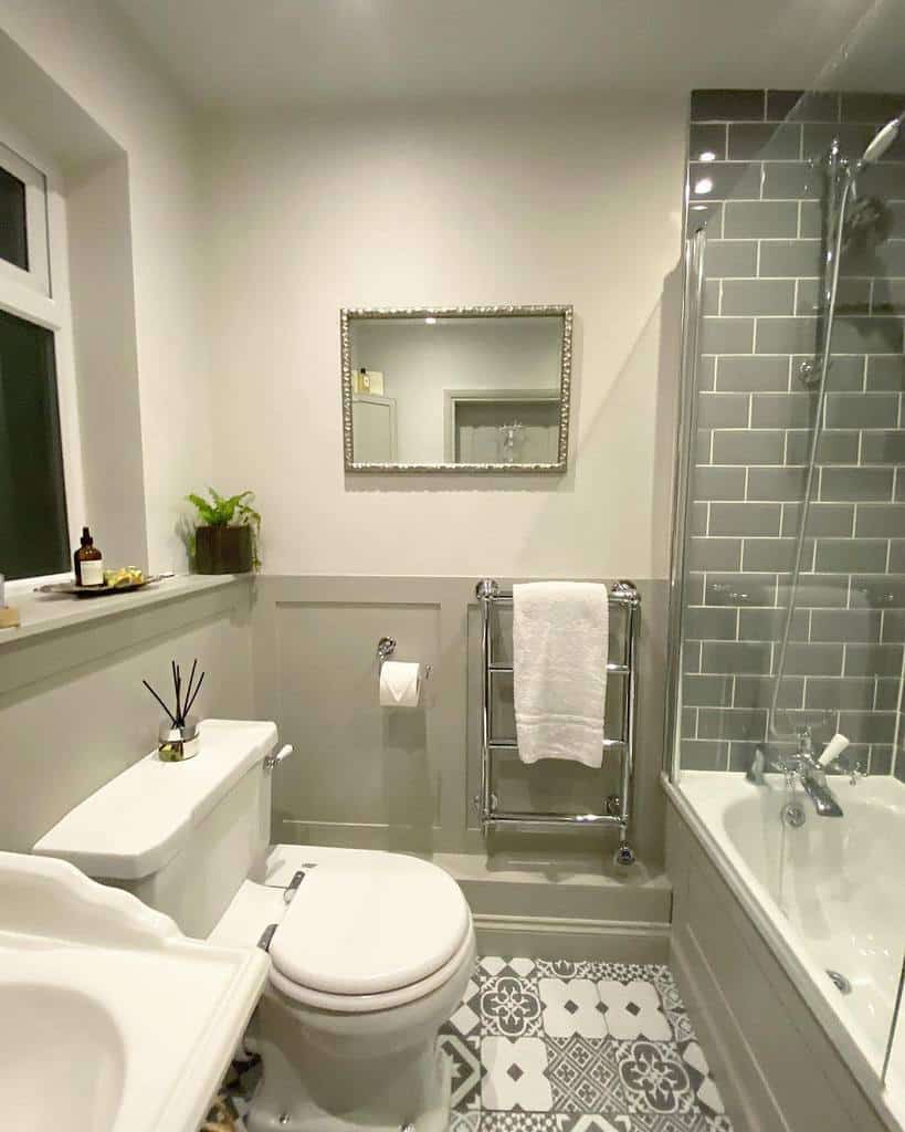 Gray bathroom shower with half wall paneling 