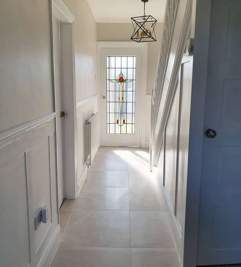 white wall paneling, hallway tile floor 