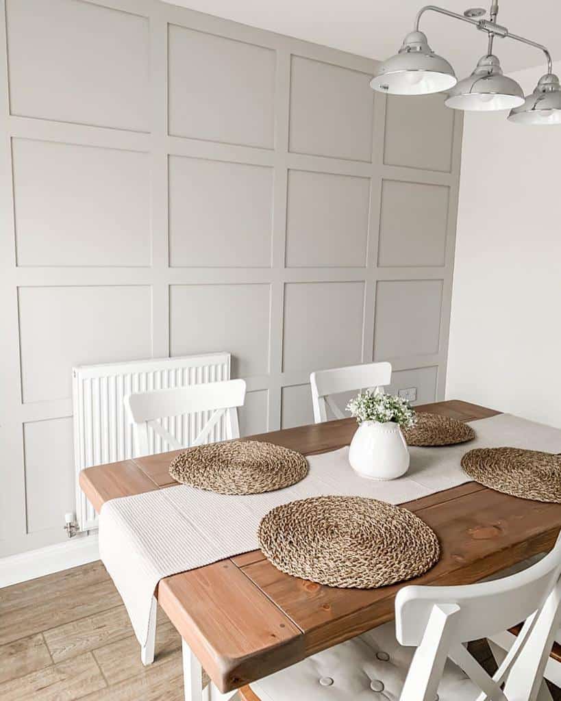 White wall paneling in the dining room with track lighting 