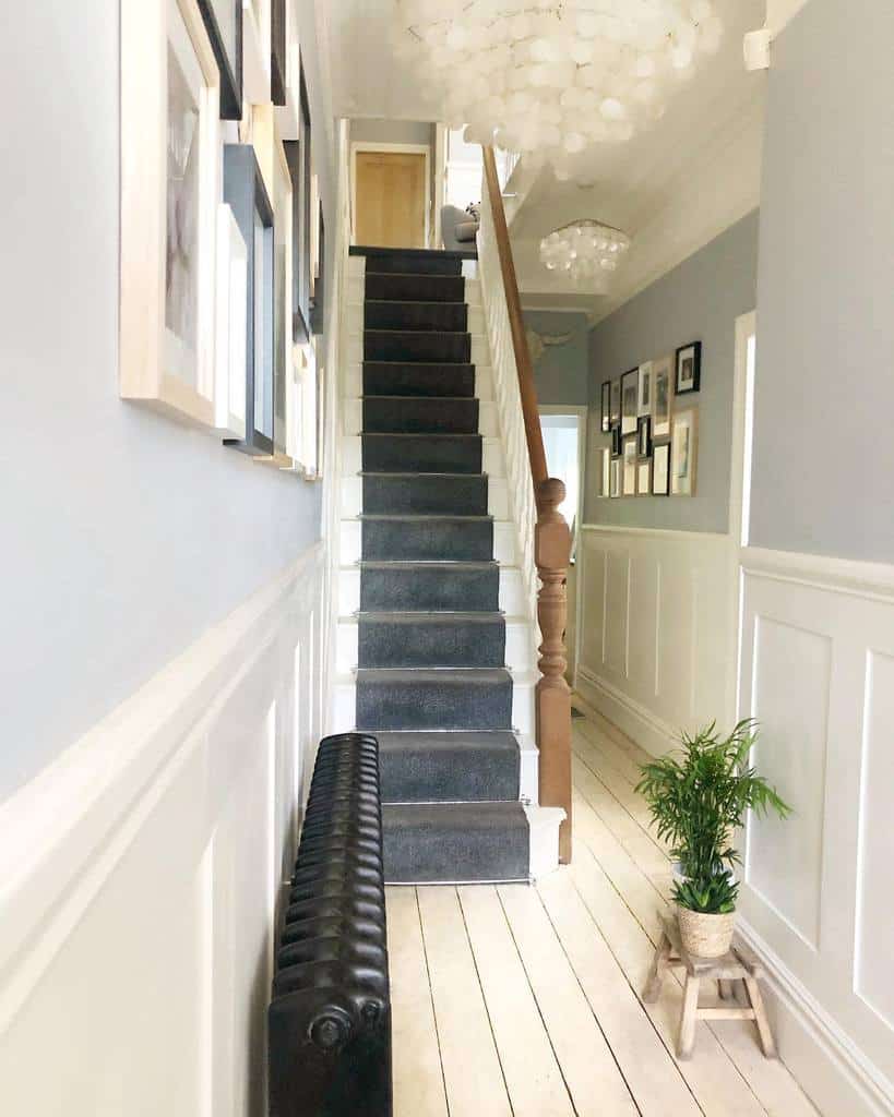 Hallway, gray carpet, stairs, wooden railing 