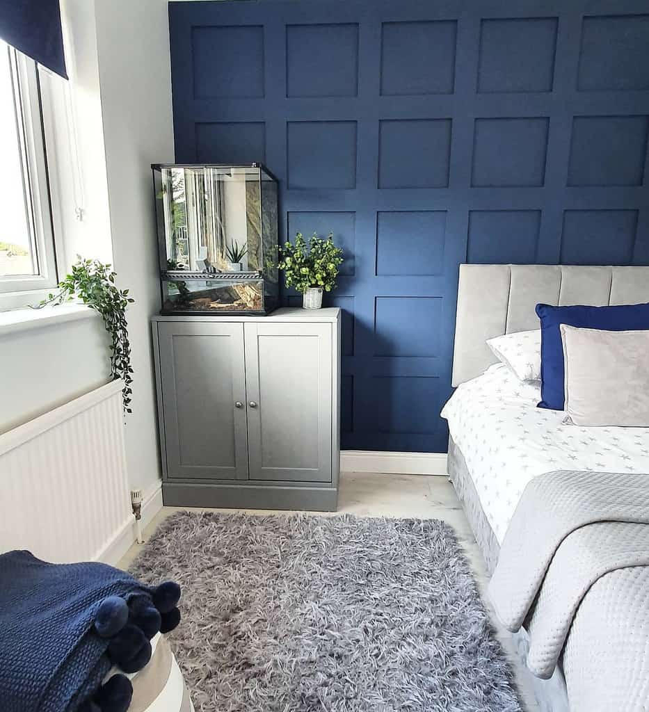 Bedroom, blue wall paneling, gray wardrobe and bed