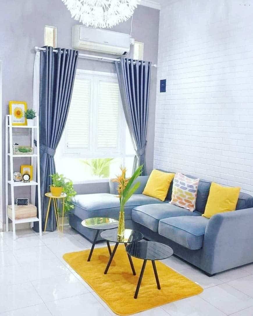 Bright living room with gray sofa and curtains 