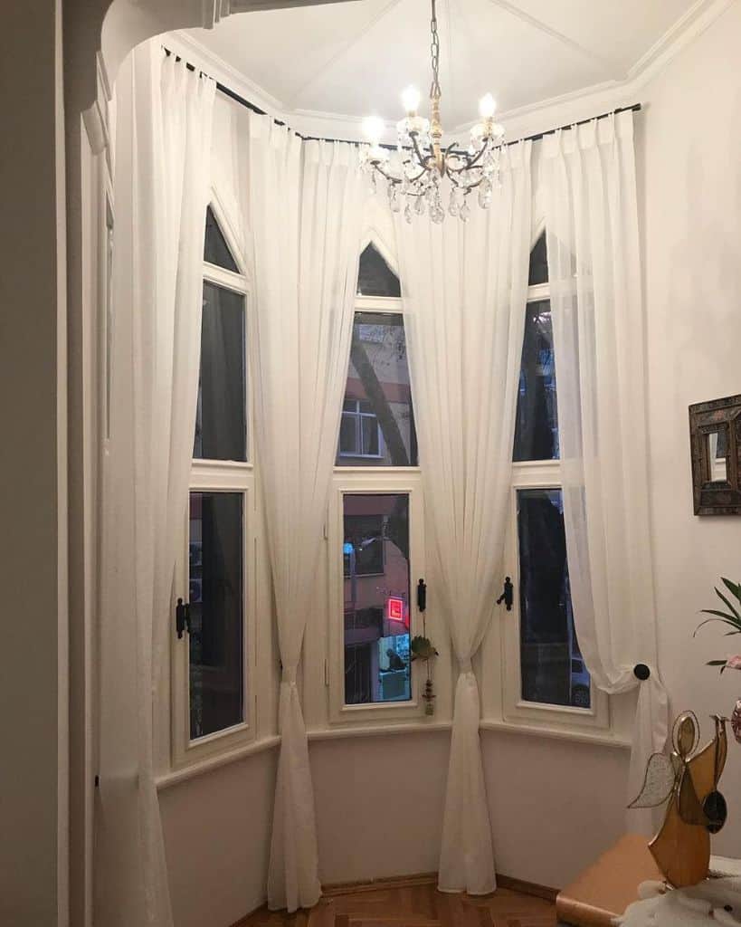 White curtains in the bay window of the living room
