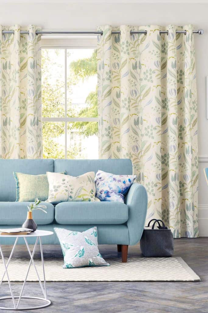 Floral print curtains, blue sofa, living room